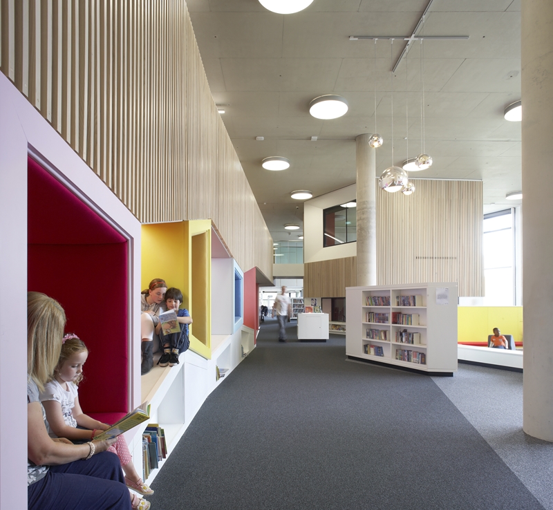 Children sit and read in the children's library.