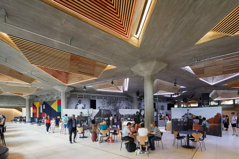 Queen Elizabeth Hall foyer with Nelson Mandela: The Centenary Exhibition 2018, fixed furniture and pendant lights by Archer Humphryes Architects, curtain by Giles Round
