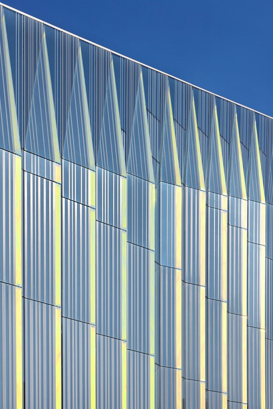 Rainbow reflective facade of MMU Business School  - FCBStudios